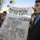 Environmental activists hold a banner during a protest against President-elect Donald Trump at the Climate Conference, known as COP22, in Marrakech, Morocco, Wednesday, Nov. 9, 2016. The election of a U.S. president who has called global warming a "hoax" alarmed environmentalists and climate scientists and raised questions about whether America, once again, would pull out of an international climate deal.